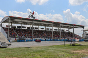 Carlisle Fairgrounds grandstand full of people during a freestyle motocross show.